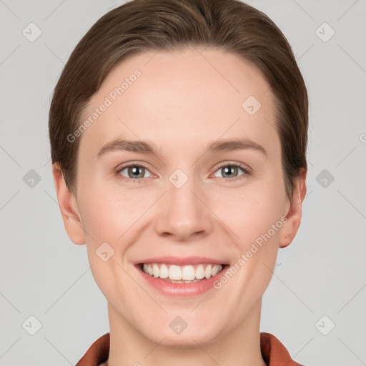 Joyful white young-adult female with short  brown hair and grey eyes