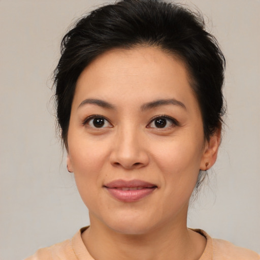 Joyful asian young-adult female with medium  brown hair and brown eyes