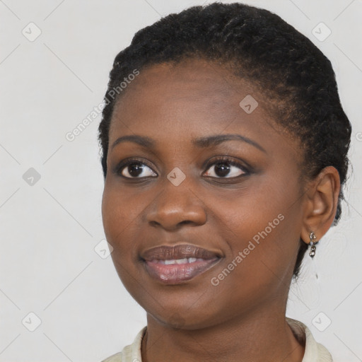 Joyful black young-adult female with short  black hair and brown eyes