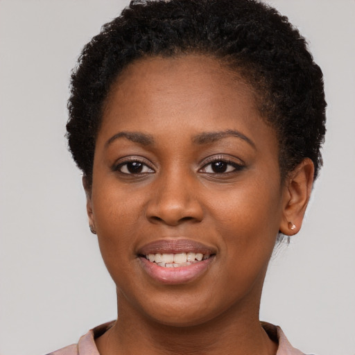 Joyful black young-adult female with short  brown hair and brown eyes