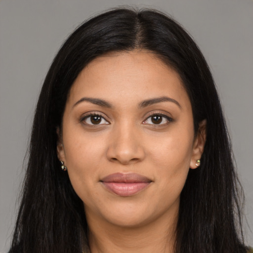 Joyful latino young-adult female with long  brown hair and brown eyes