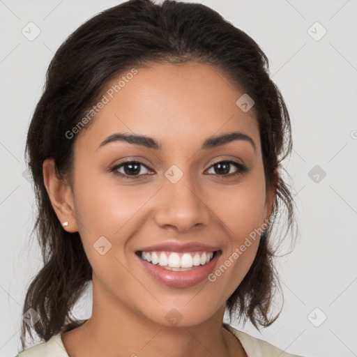 Joyful latino young-adult female with medium  brown hair and brown eyes