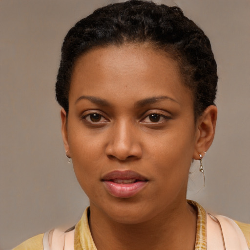 Joyful black young-adult female with short  brown hair and brown eyes