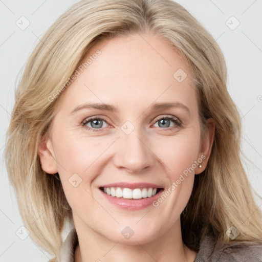 Joyful white young-adult female with medium  brown hair and blue eyes