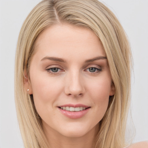 Joyful white young-adult female with long  brown hair and blue eyes