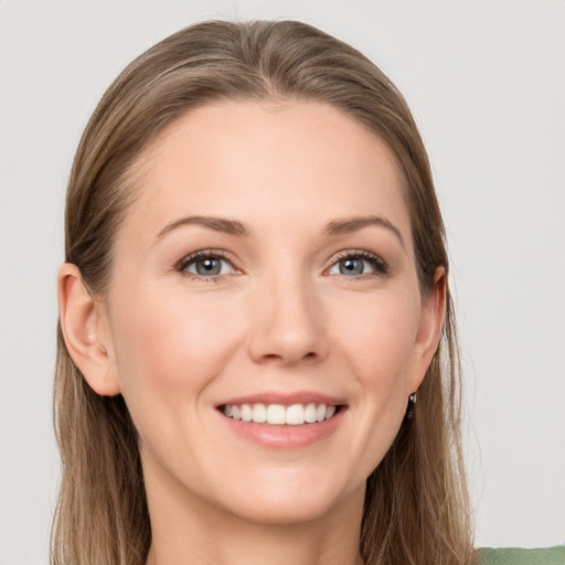 Joyful white young-adult female with long  brown hair and grey eyes