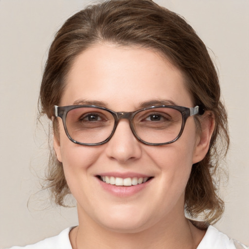 Joyful white adult female with medium  brown hair and green eyes