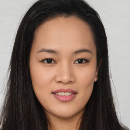 Joyful asian young-adult female with long  brown hair and brown eyes