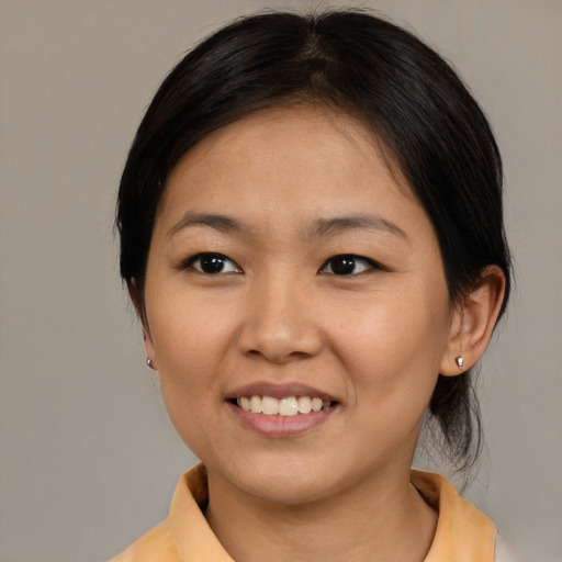 Joyful asian young-adult female with medium  brown hair and brown eyes