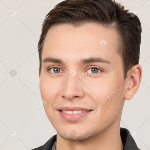 Joyful white young-adult male with short  brown hair and brown eyes