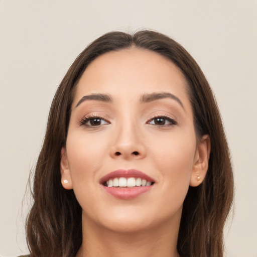 Joyful white young-adult female with long  brown hair and brown eyes