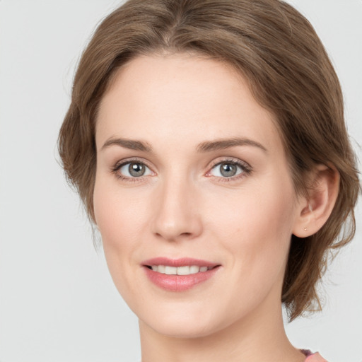 Joyful white young-adult female with medium  brown hair and green eyes