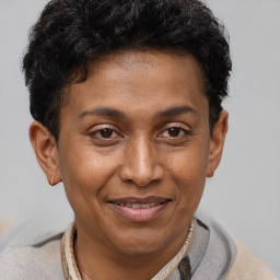 Joyful latino adult male with short  brown hair and brown eyes