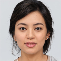 Joyful asian young-adult female with medium  brown hair and brown eyes