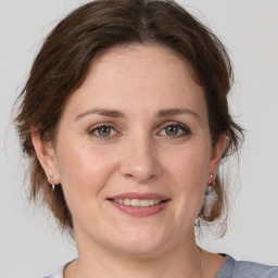 Joyful white young-adult female with medium  brown hair and grey eyes