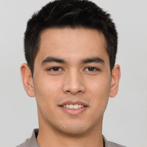 Joyful asian young-adult male with short  brown hair and brown eyes