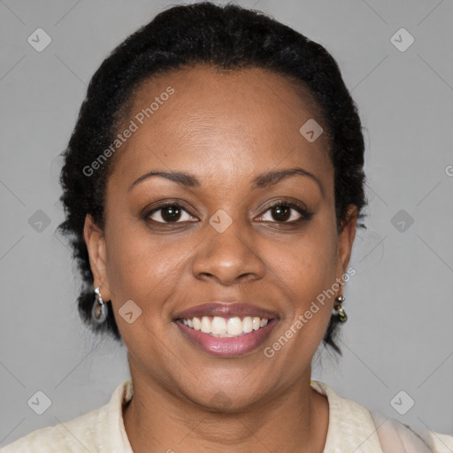 Joyful black adult female with short  brown hair and brown eyes