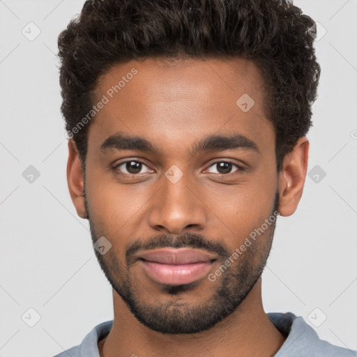 Joyful black young-adult male with short  brown hair and brown eyes