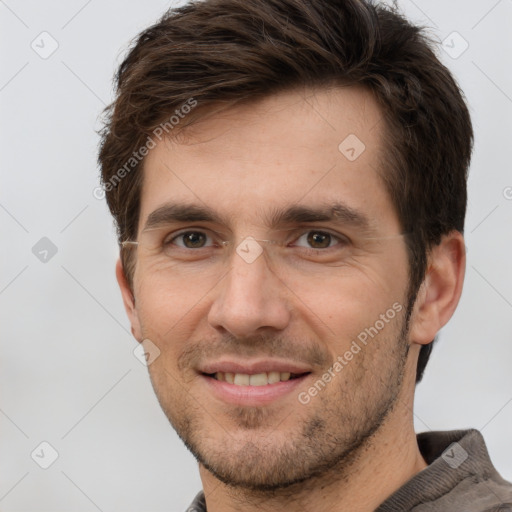 Joyful white young-adult male with short  brown hair and grey eyes