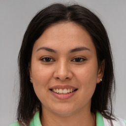 Joyful latino young-adult female with medium  brown hair and brown eyes