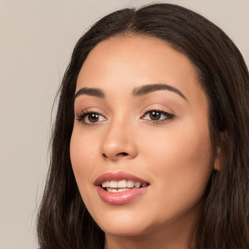 Joyful white young-adult female with long  black hair and brown eyes