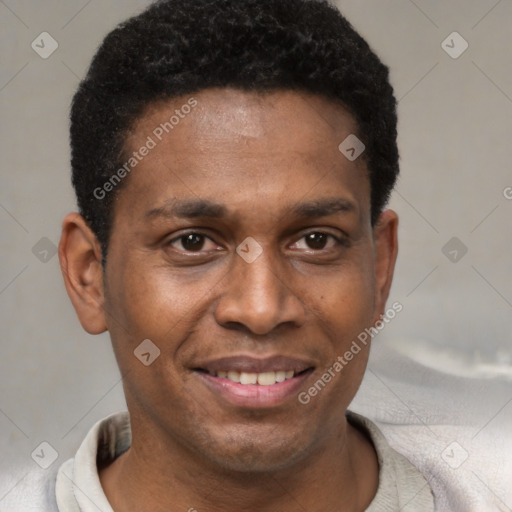 Joyful black young-adult male with short  black hair and brown eyes