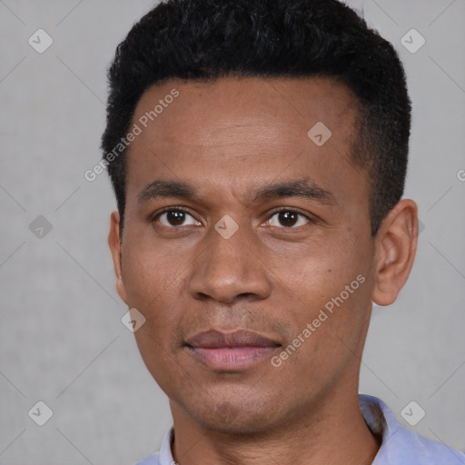 Joyful black young-adult male with short  black hair and brown eyes