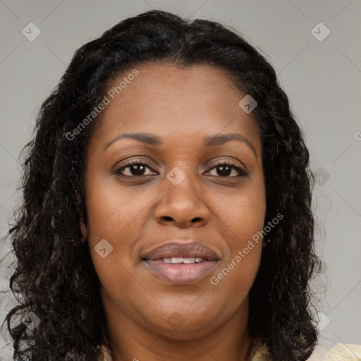 Joyful black young-adult female with long  brown hair and brown eyes