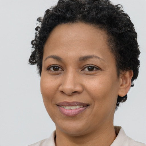 Joyful latino adult female with short  brown hair and brown eyes