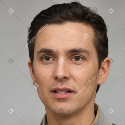 Joyful white adult male with short  brown hair and brown eyes