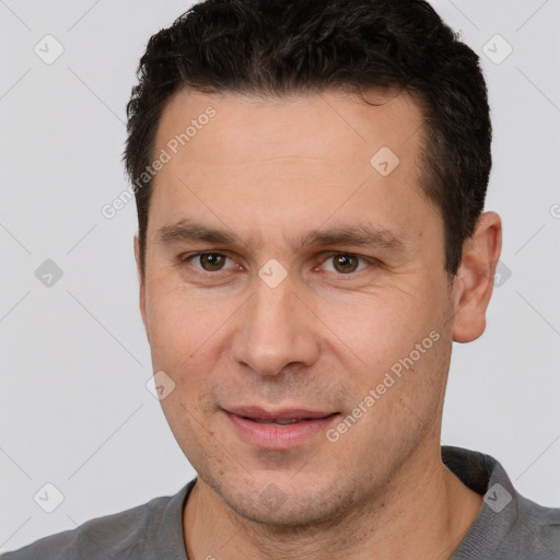 Joyful white adult male with short  brown hair and brown eyes