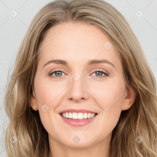 Joyful white young-adult female with long  brown hair and grey eyes