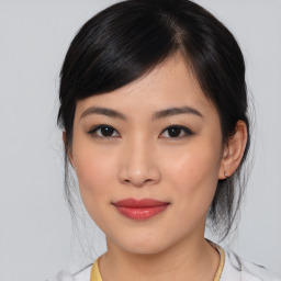 Joyful asian young-adult female with medium  black hair and brown eyes