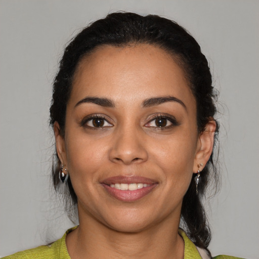 Joyful latino young-adult female with medium  black hair and brown eyes