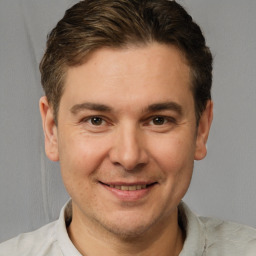 Joyful white young-adult male with short  brown hair and brown eyes