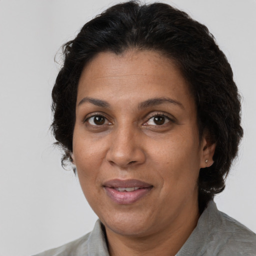 Joyful latino adult female with short  brown hair and brown eyes