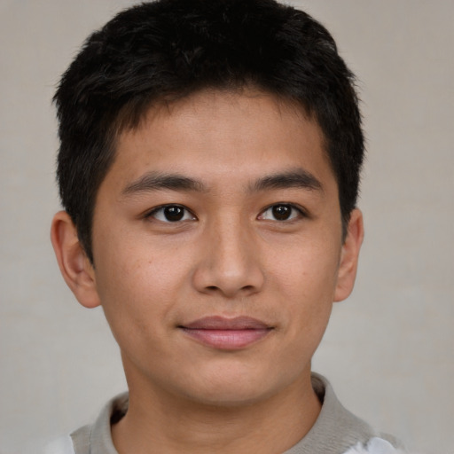 Joyful asian young-adult male with short  brown hair and brown eyes