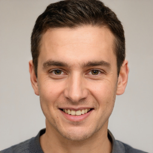 Joyful white young-adult male with short  brown hair and brown eyes