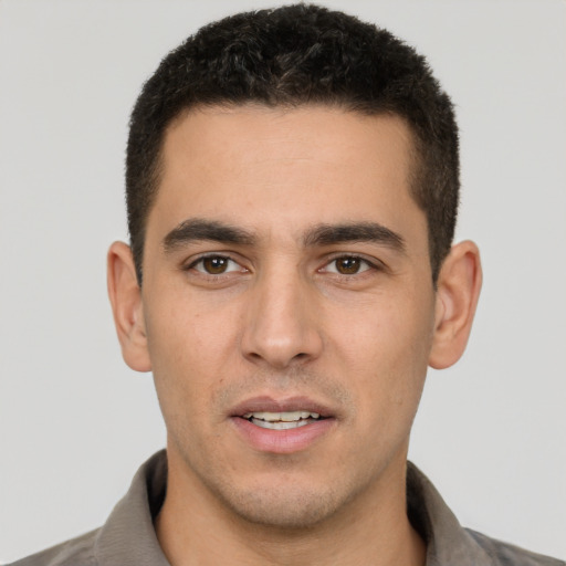 Joyful white young-adult male with short  brown hair and brown eyes