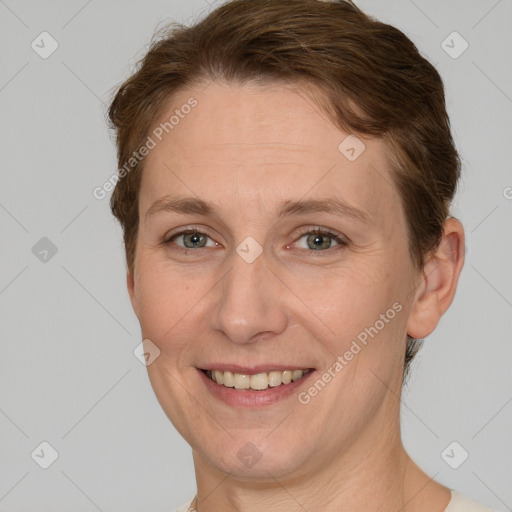 Joyful white adult female with short  brown hair and grey eyes