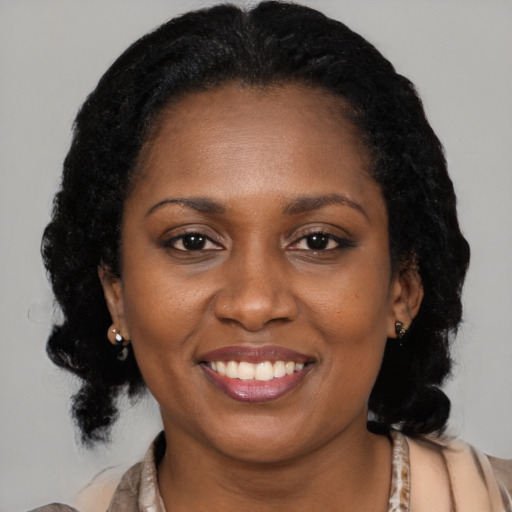 Joyful latino young-adult female with medium  black hair and brown eyes