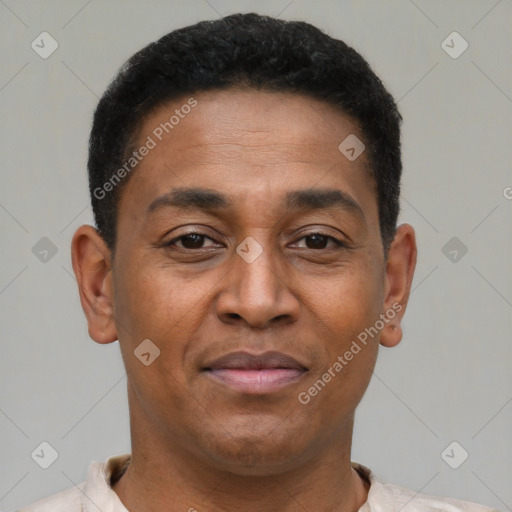 Joyful latino young-adult male with short  brown hair and brown eyes
