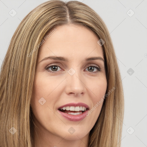 Joyful white young-adult female with long  brown hair and brown eyes