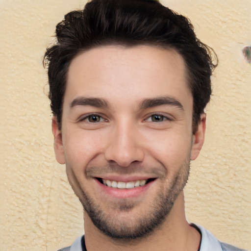 Joyful white young-adult male with short  black hair and brown eyes