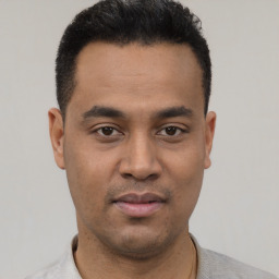 Neutral latino young-adult male with short  black hair and brown eyes