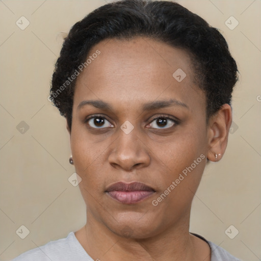 Joyful black young-adult female with short  black hair and brown eyes