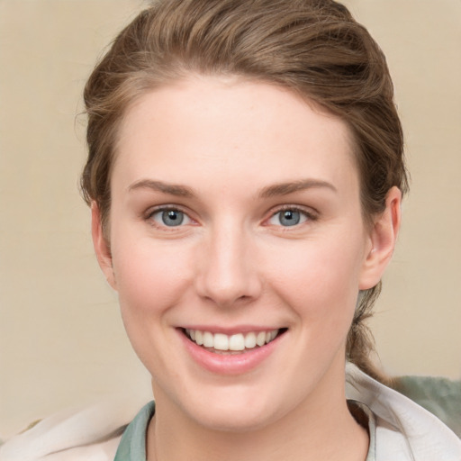 Joyful white young-adult female with medium  brown hair and blue eyes