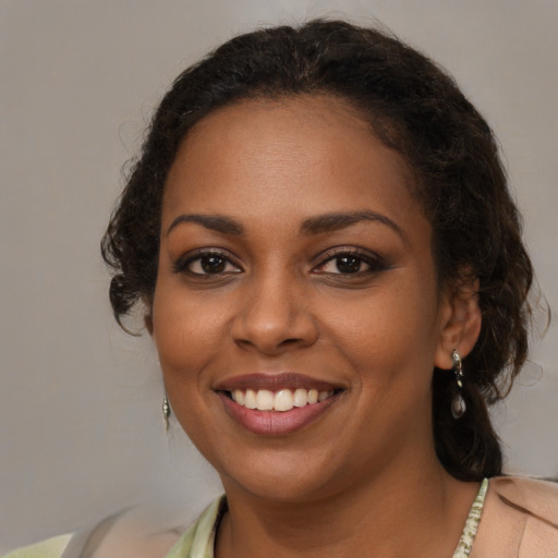 Joyful black young-adult female with medium  brown hair and brown eyes