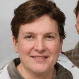 Joyful white adult female with medium  brown hair and blue eyes