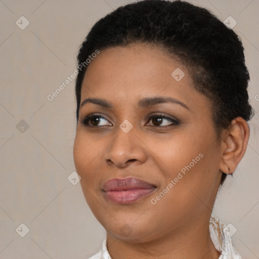 Joyful black young-adult female with short  brown hair and brown eyes